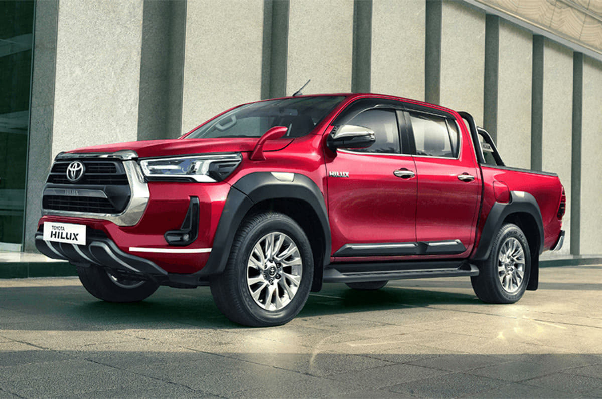 Original India-spec Toyota Hilux eighth generation (2022–2026), Emotional Red, OEM press front three-quarter
