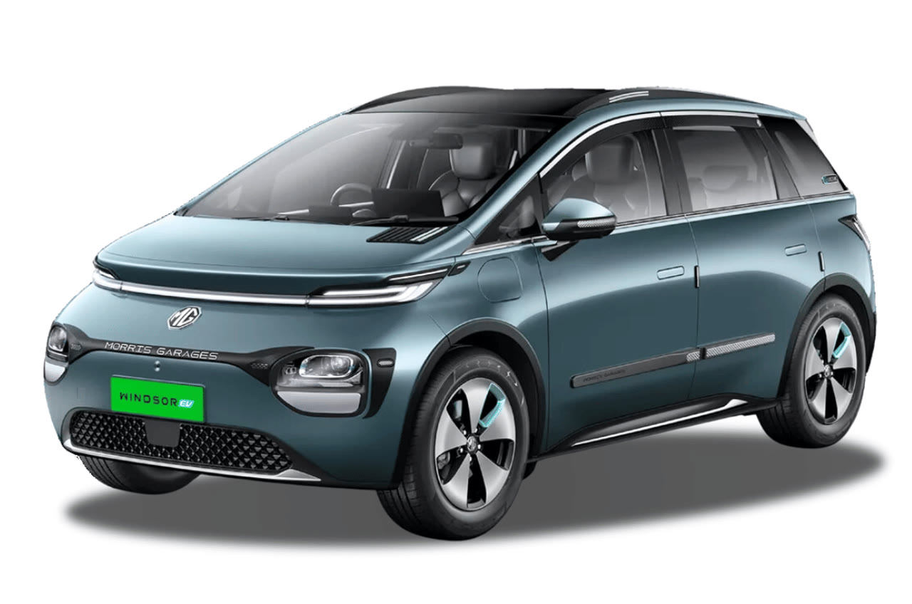 Current India-spec MG Windsor EV, metallic teal, front three-quarter studio with green EV plate