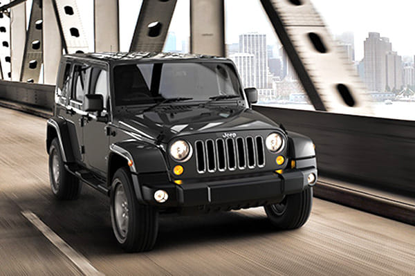 India-spec Jeep Wrangler Unlimited JK (2016–2019), dark metallic, OEM press front three-quarter